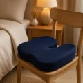 Navy orthopedic memory foam seat cushion on a wooden chair